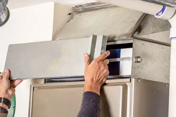 person removing furnace panel